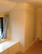 White glass in white frames fitted into the eaves of a room (opposite side)