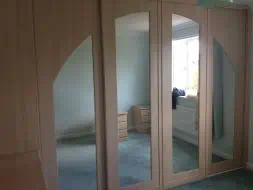 Hand routed 4 door arch with inset mirrors