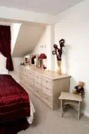 12 drawer fitted unit made to fit within the eaves of the room