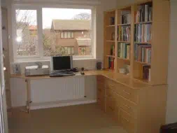 A full view of the corner desk and bookcase