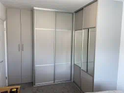 L shape wardrobes with wood, coloured glass and mirror