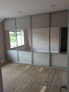Wooden cashmere panels at the top and bottom with mirror in the middle, fitted in Darlington