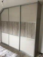Sliding doors divided into thirds with a dark artwood panel in the middle and pearl white glass top and bottom, fitted in Whitby