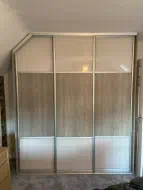 Narrow sliding doors with coloured glass top and bottom and wood in the center, fitted in Ingleby Barwick
