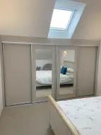 Taylor Made sliding shaker doors with mirrors all installed into the eaves of the room, fitted in Darlington